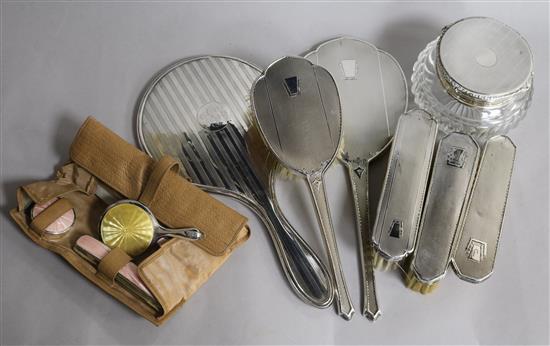 Mixed dressing table items including silver brushes, silver mirrors and silver mounted powder jar.